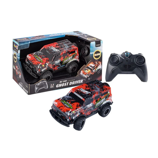 Revell Ghost Driver RC stunt car in a vibrant red and multicolor finish, featuring oversized all-terrain tires, a low-profile aerodynamic body, and a 2.4 GHz pistol-grip remote control.