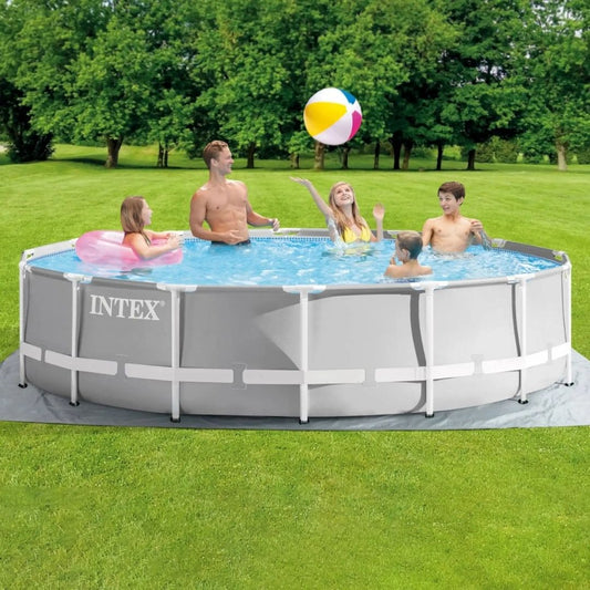 Intex Prism Frame Pool Set featuring a round light gray pool with a white reinforced steel frame, shown on a green lawn with a family playing inside.