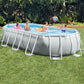 Intex Prism Frame Oval Pool featuring a light gray liner and white reinforced steel frame supports, shown on a green lawn with a family playing inside.