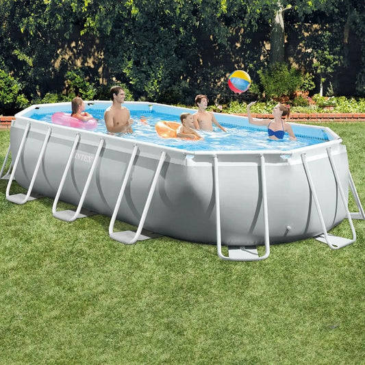 Intex Prism Frame Oval Pool featuring a light gray liner and white reinforced steel frame supports, shown on a green lawn with a family playing inside.