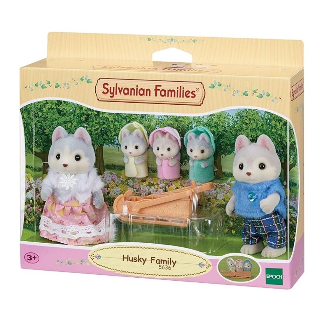 Vibrant multicolor Sylvanian Families Husky Family set featuring two adult husky figures in detailed fabric clothing and three triplets sitting in a small yellow push-along sled.