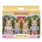 Vibrant multicolor Sylvanian Families Milk Rabbit Family set featuring four soft-flocked cream rabbit figures with pink-tipped ears in detailed removable fabric outfits.